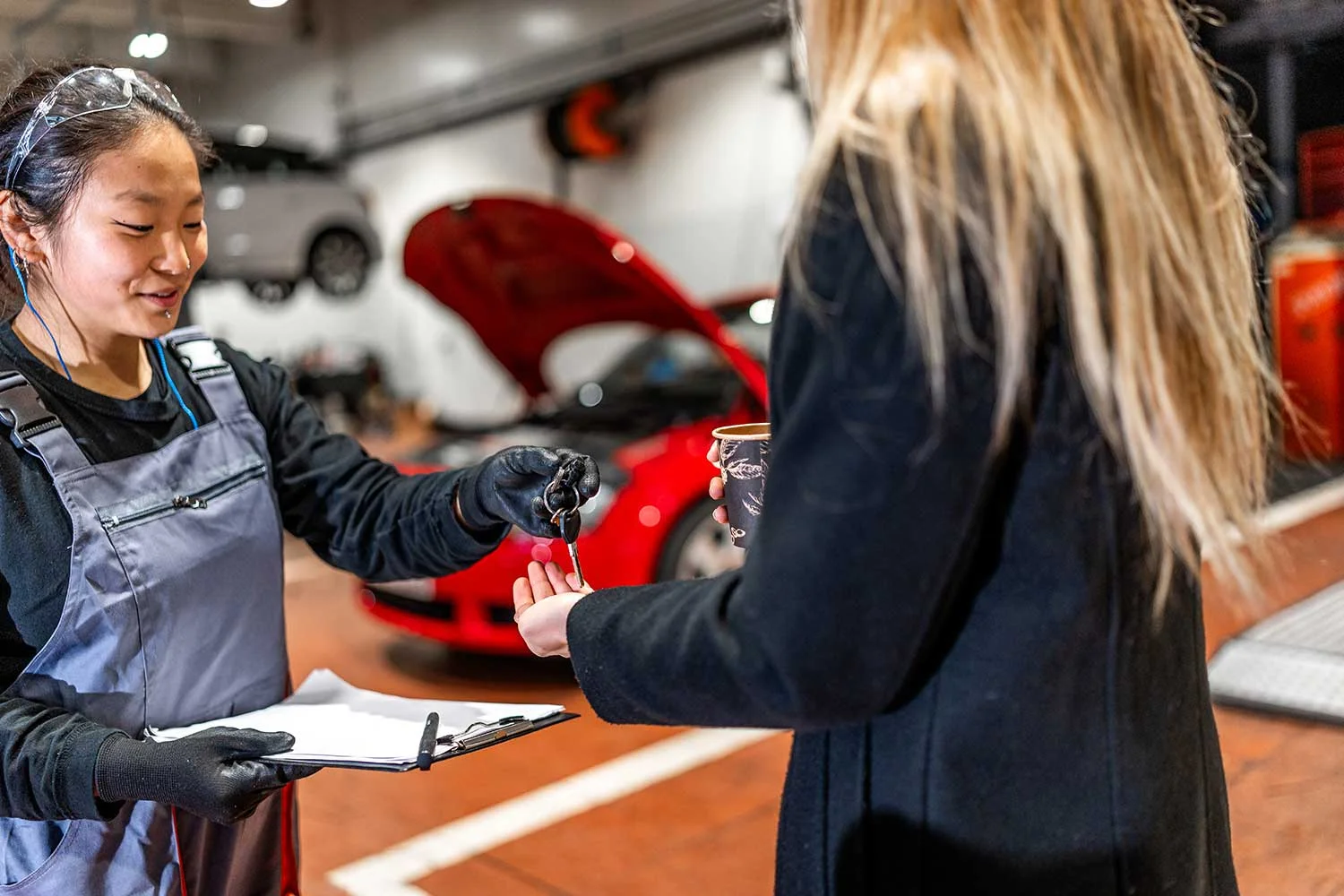 female-mechanic-delivering-car-keys-to-customer